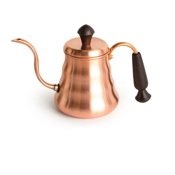 Handcrafted copper tea kettle with nickel-plated interior on a stovetop, boiling water.